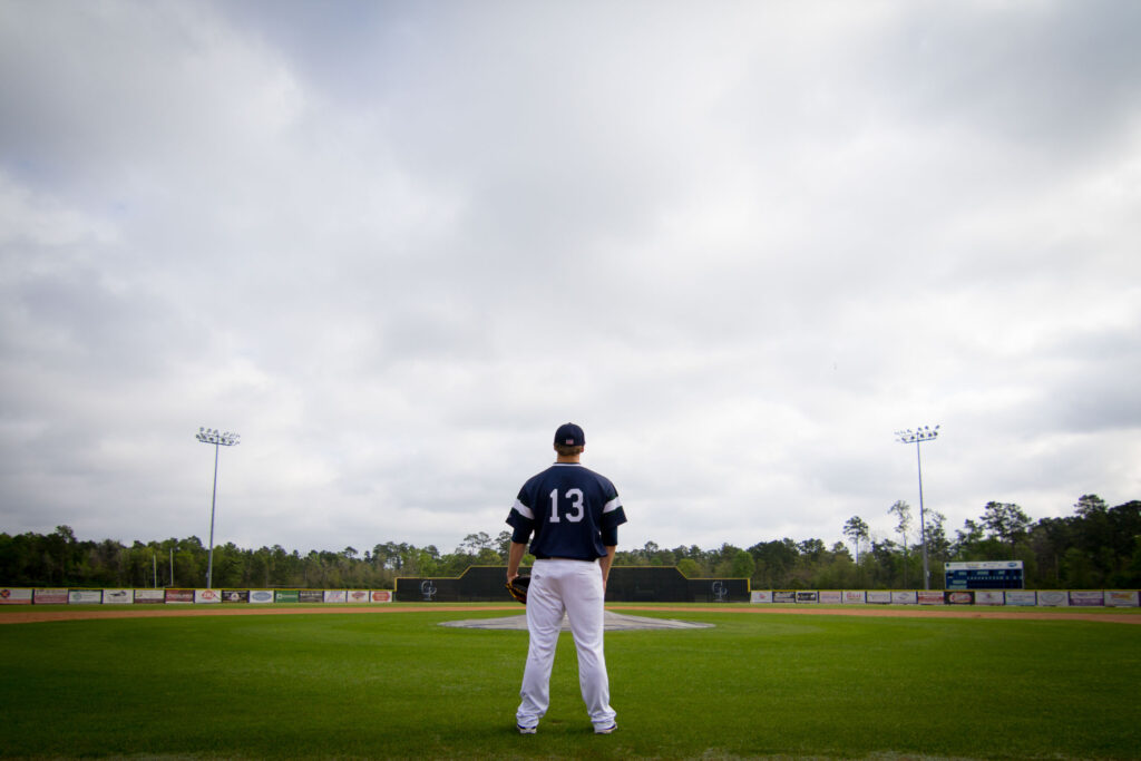 College Park High School baseball field. Senior in jersey staring at field.