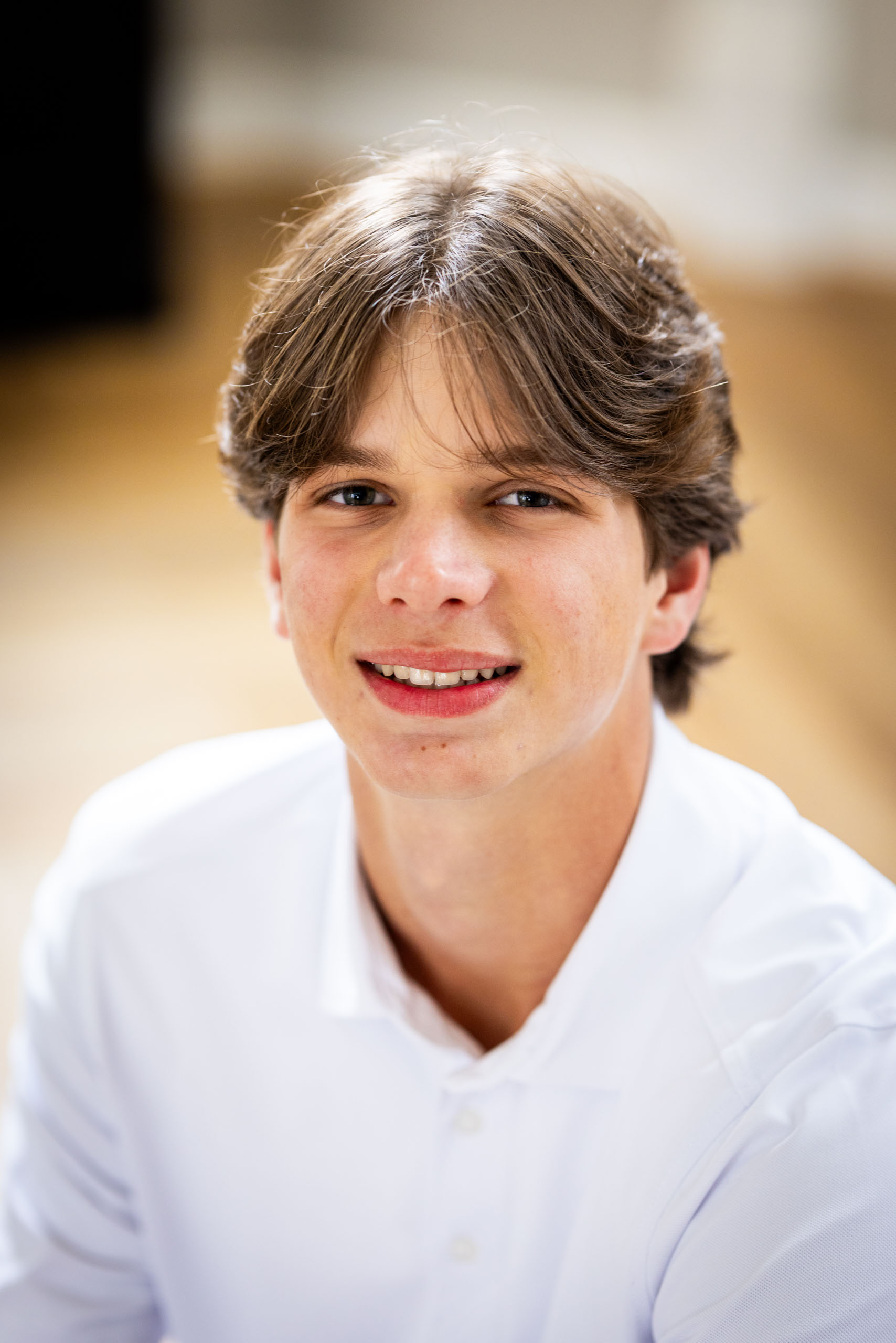 High school senior boy in white polo shirt